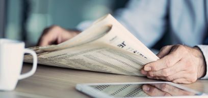 Hands holding a newspaper