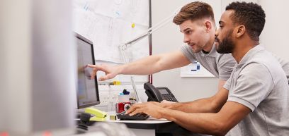 Two man looking at a computer
